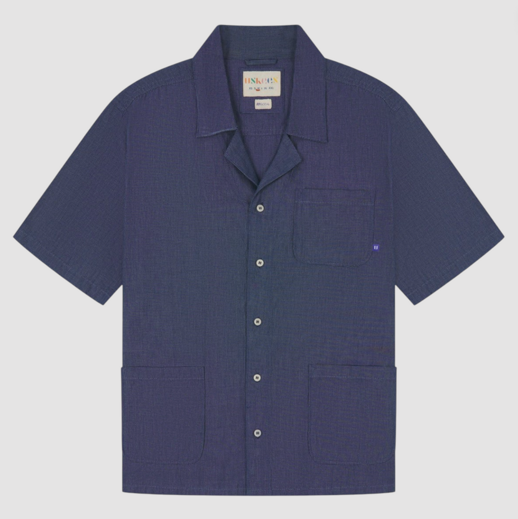 Oxford chambray Cuban shirt with notched collar, corozo buttons, and chest pockets.