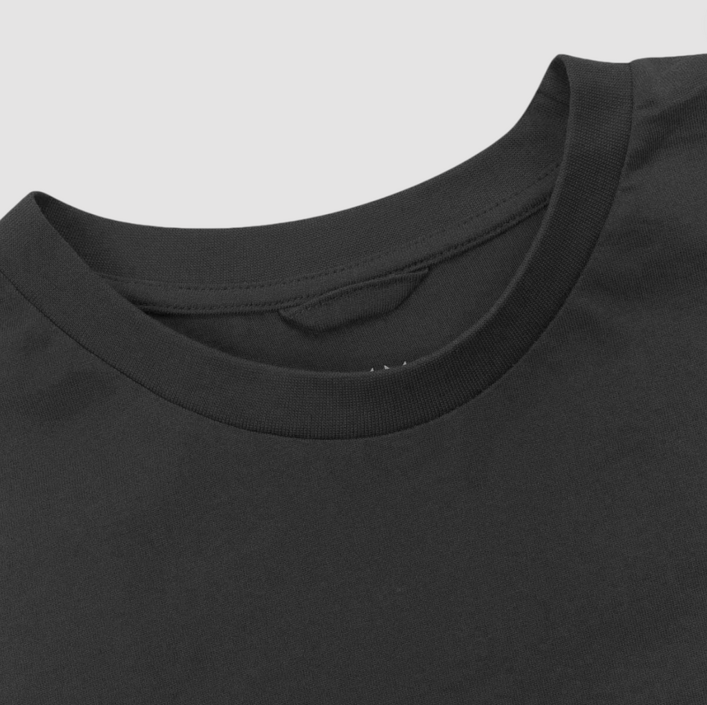 Close-up of a black t-shirt collar on a light gray background.