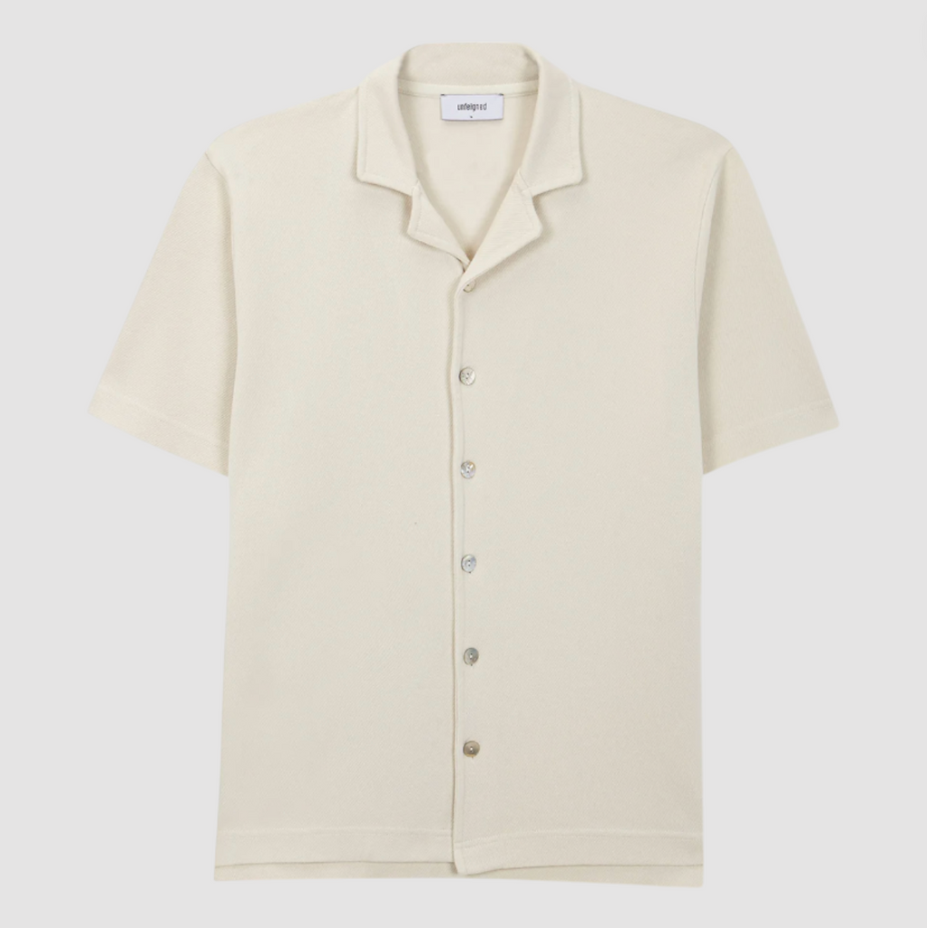 A lightweight polo shirt draped naturally, showcasing its breezy fit and premium stitching.