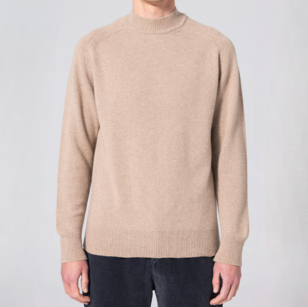 Beige turtleneck sweater crafted from a luxurious cashmere and merino wool blend, featuring raglan sleeves and ribbed hem and cuffs.