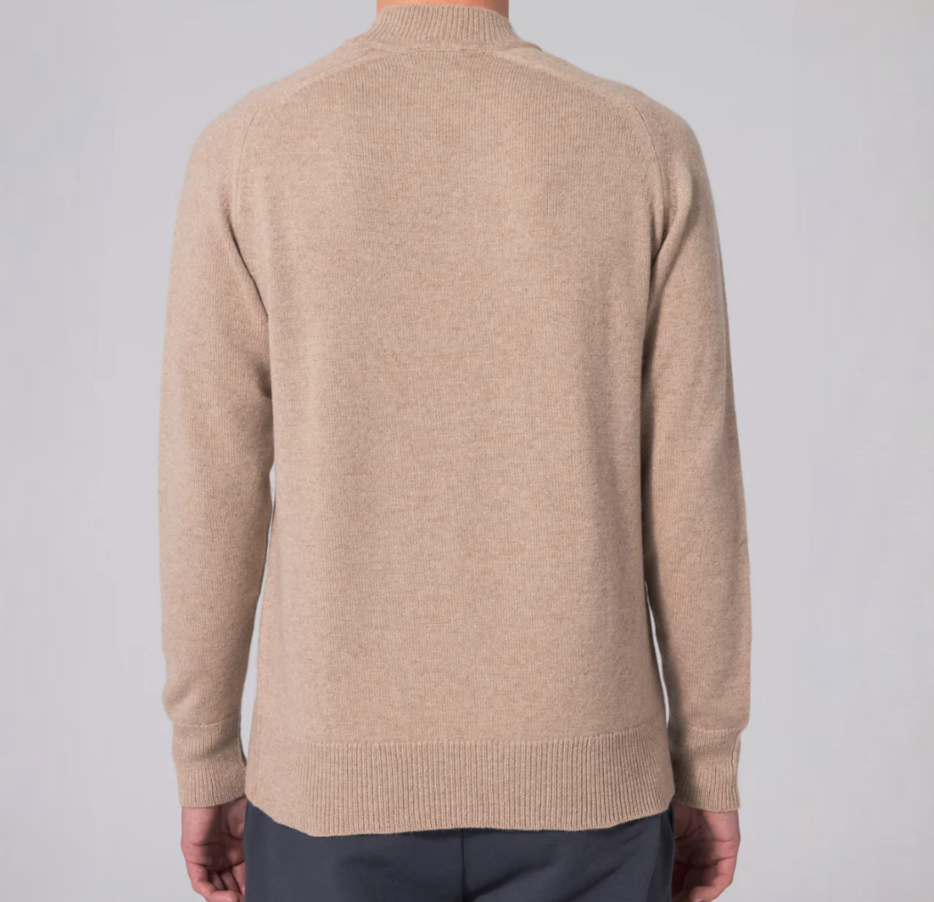 Beige turtleneck sweater crafted from a luxurious cashmere and merino wool blend, featuring raglan sleeves and ribbed hem and cuffs.