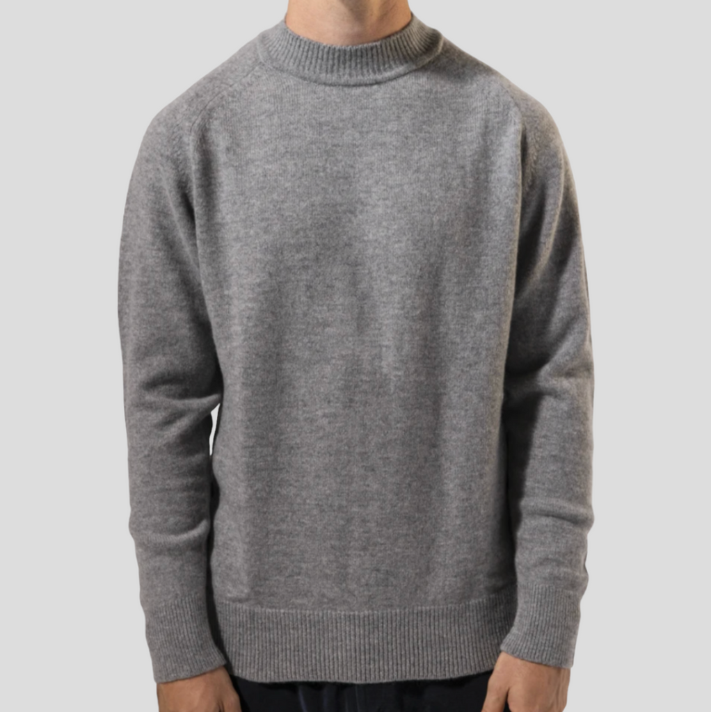 Lightweight grey turtleneck sweater in a premium cashmere and merino blend, styled with raglan sleeves and ribbed finishes.