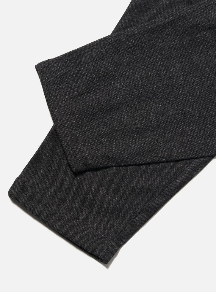 Dark gray pants folded on a light gray background.
