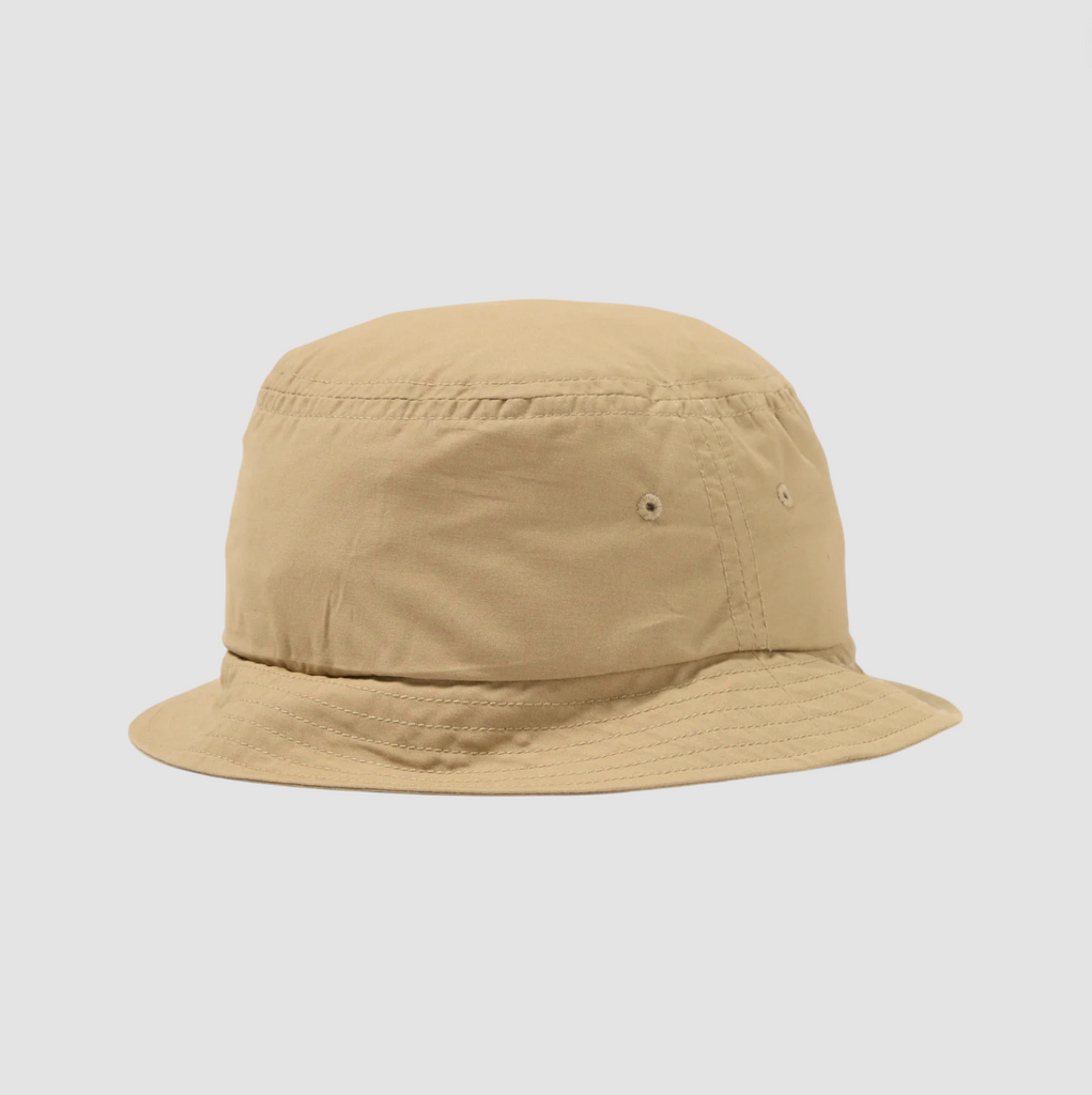 Sand-colored short-brim bucket hat with a five-panel construction, mesh lining, stitched brim, and dual eyelets for ventilation.