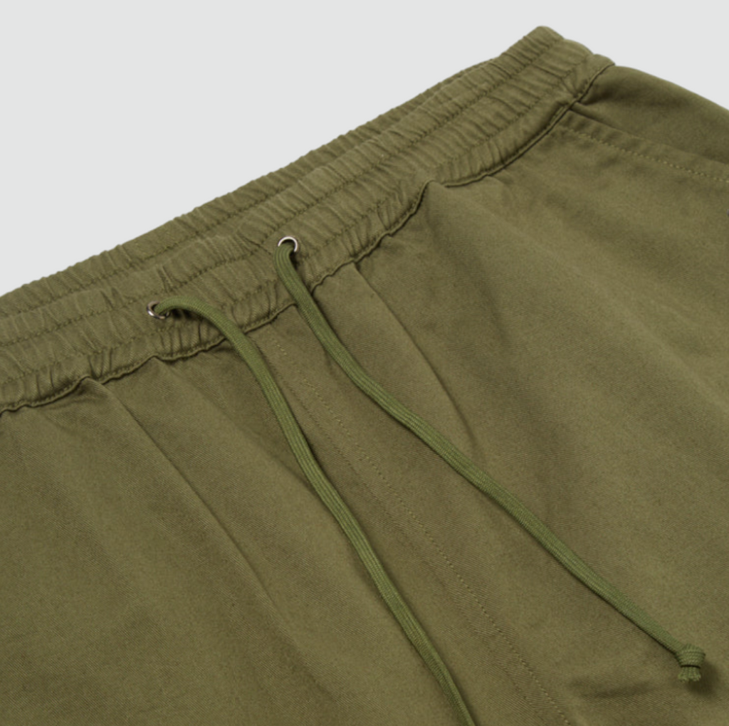 Casual summer shorts in light olive with front and back pockets, crafted from 100% cotton.