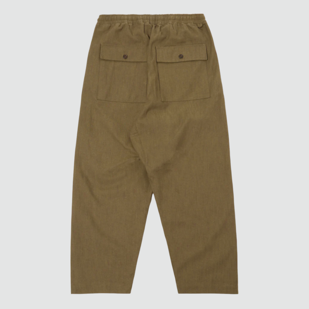 Olive green loose-fitting cotton pants with a drawstring waist, large front and back patch pockets, and wide hems. Made from durable twill weave fabric.