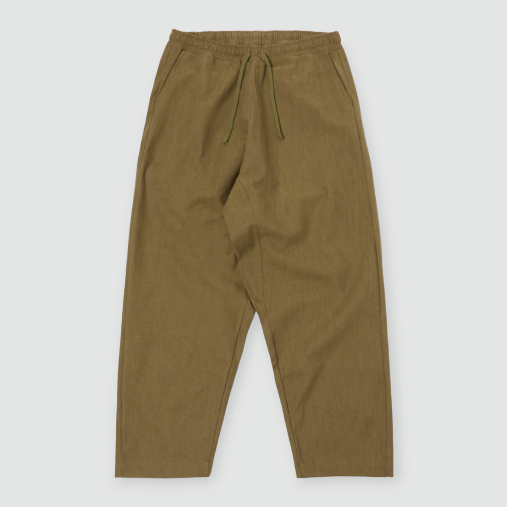 Olive green loose-fitting cotton pants with a drawstring waist, large front and back patch pockets, and wide hems. Made from durable twill weave fabric.