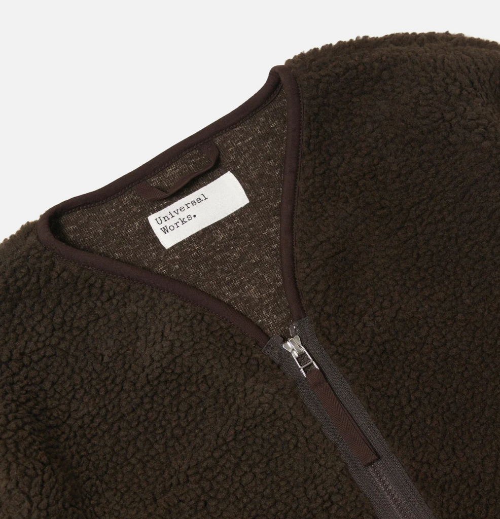 Brown fleece jacket with a visible brand label on a white background.