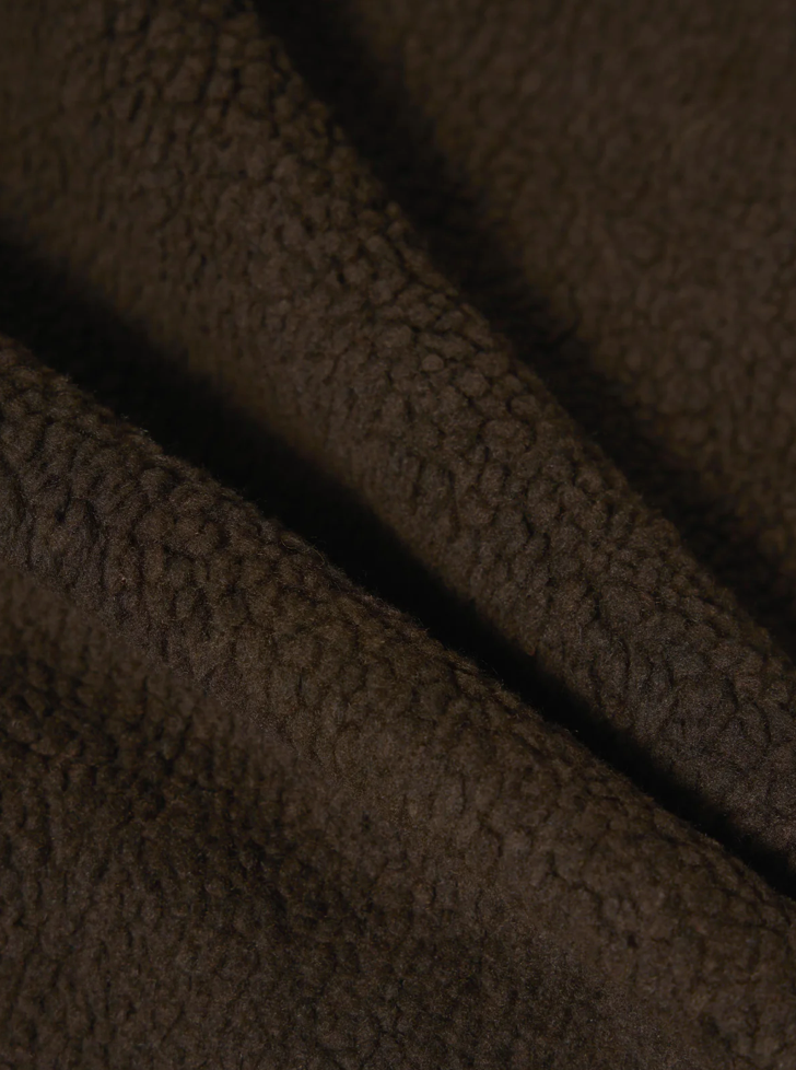 Close-up of brown textured fabric.