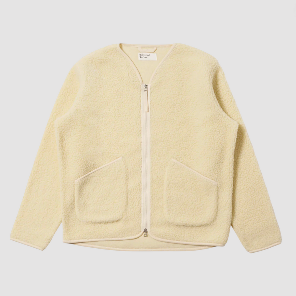 Ecru fleece jacket with a zipper on a light gray background.