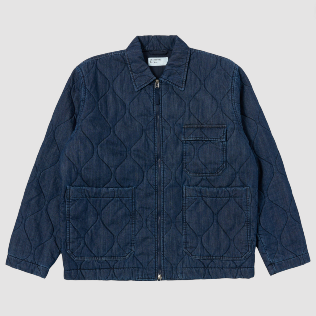 Quilted denim jacket with a diamond pattern on a light gray background