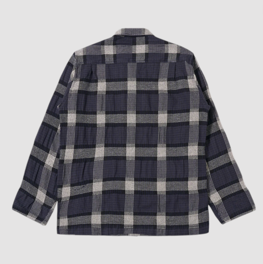 Plaid shirt with navy and white pattern on a light gray background.