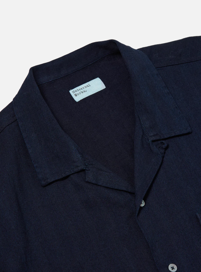 Indigo herringbone denim shirt featuring a loop-close collar, straight hem, and single chest patch pocket in a regular fit.