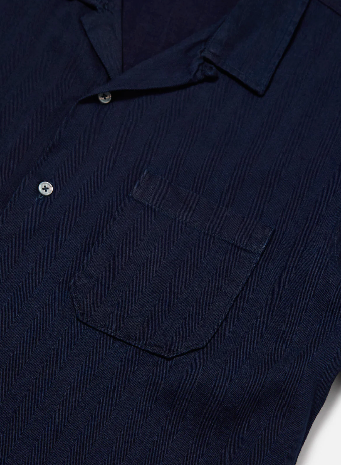 Indigo herringbone denim shirt featuring a loop-close collar, straight hem, and single chest patch pocket in a regular fit.