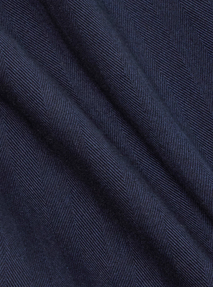 Indigo herringbone denim shirt featuring a loop-close collar, straight hem, and single chest patch pocket in a regular fit.