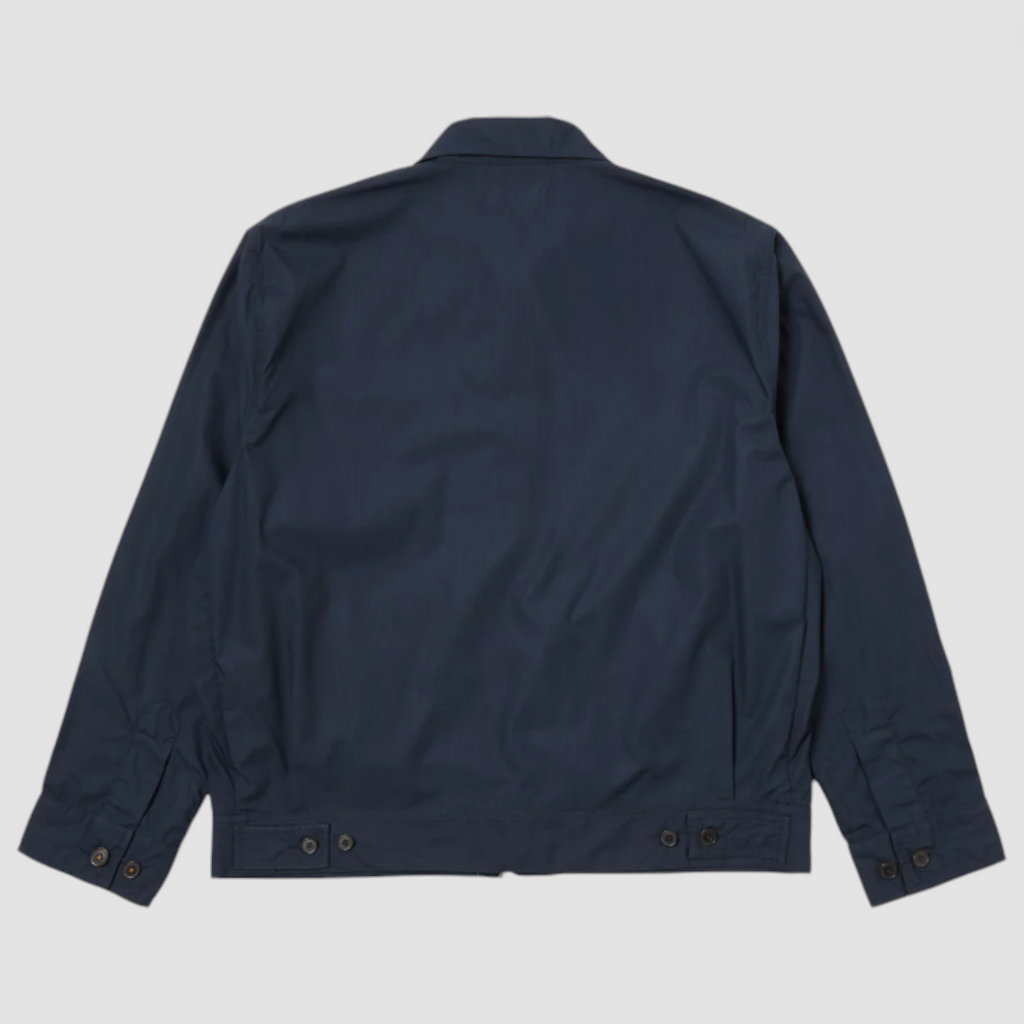 Navy boxy-fit jacket with an oversized collar, zip front, large patch pocket, welt pockets, pleated details, and an adjustable back hem.