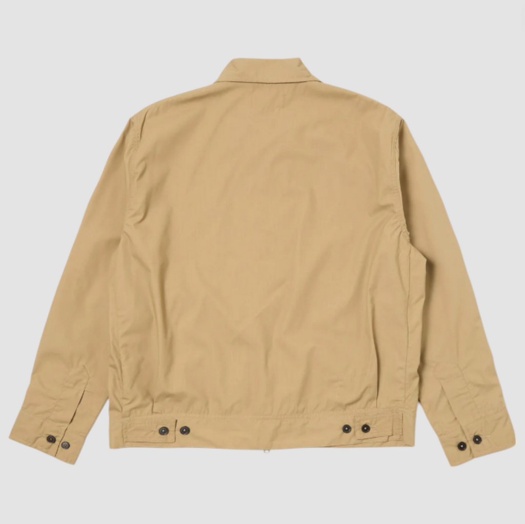 Sand-colored boxy-fit jacket with an oversized collar, zip front, large patch pocket, welt pockets, pleated details, and an adjustable back hem.