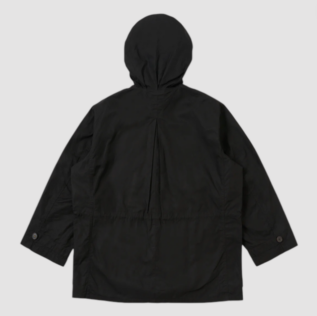 Black hooded wax coat on a light grey background.