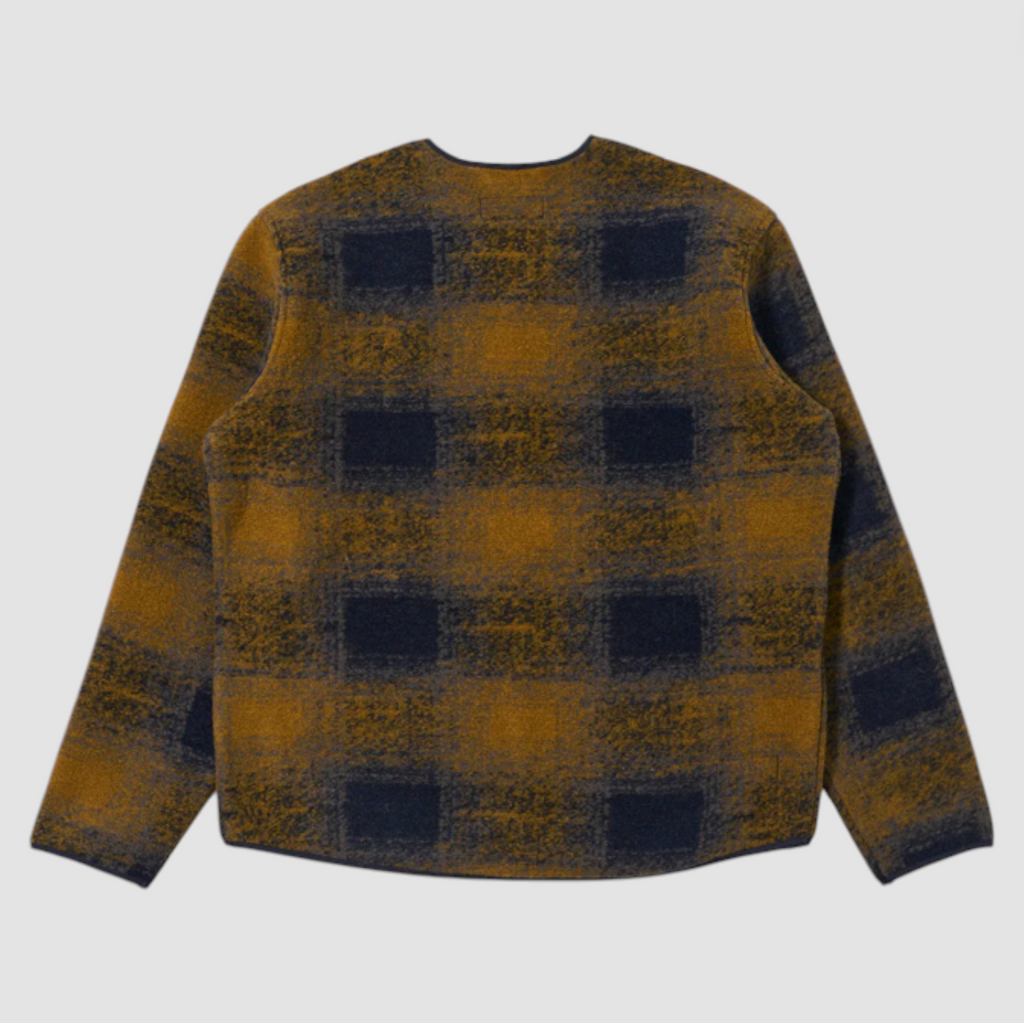 Navy and yellow checkered pattern wool fleece zip up cardigan on a grey background.