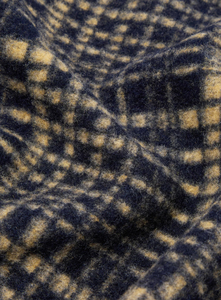 Close-up of a blue and beige checkered fabric texture.