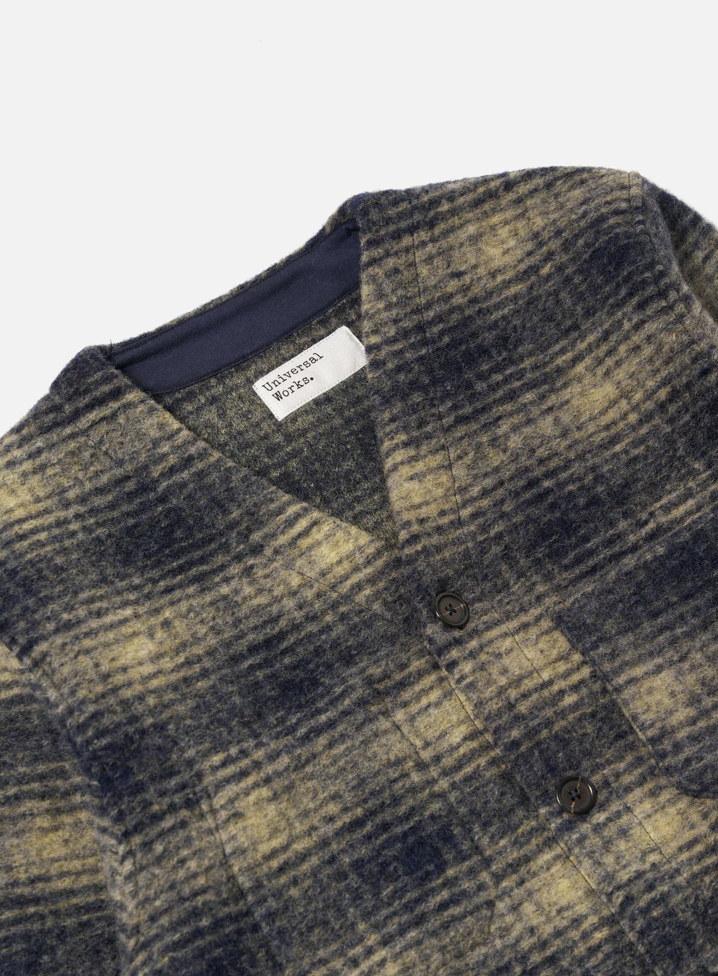 Beige and navy checkered print fleece cardigan on pale grey background. 