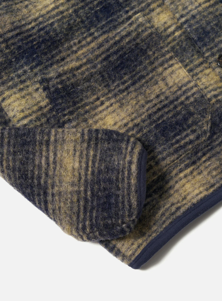 Beige and navy checkered print fleece cardigan on pale grey background. 