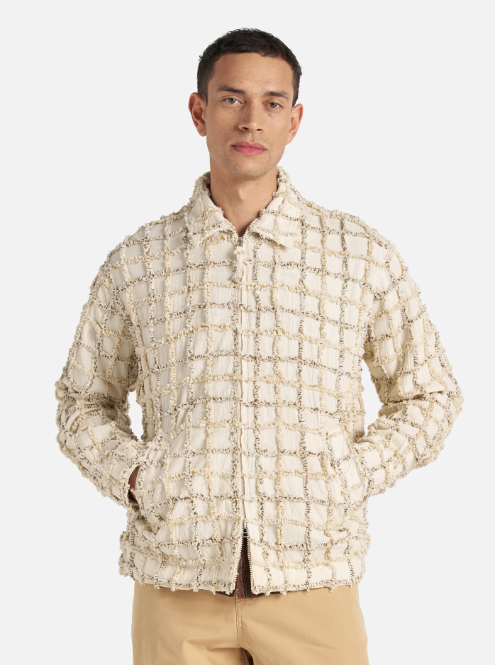 Ecru check cotton jacket with a two-way zip front, chest and hand pockets, and adjustable cuffs and rear waist tabs.