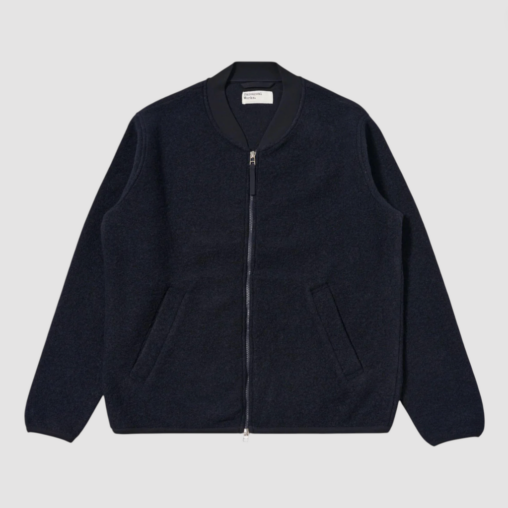 Dark blue jacket with a zipper on a light gray background.