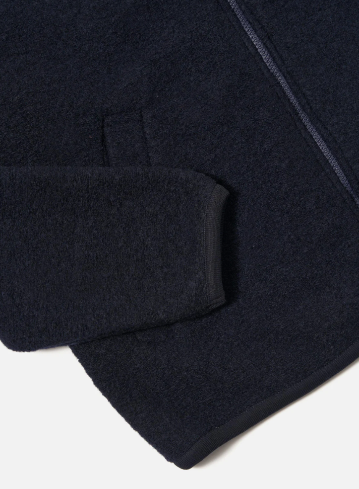 Close-up of a dark blue fabric texture on a white background.