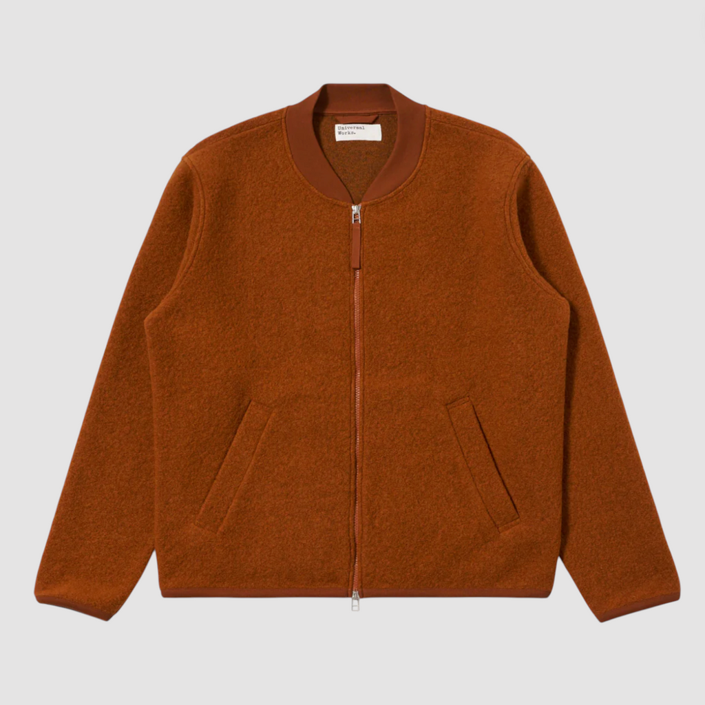 Orange zip-up jacket on a light gray background.
