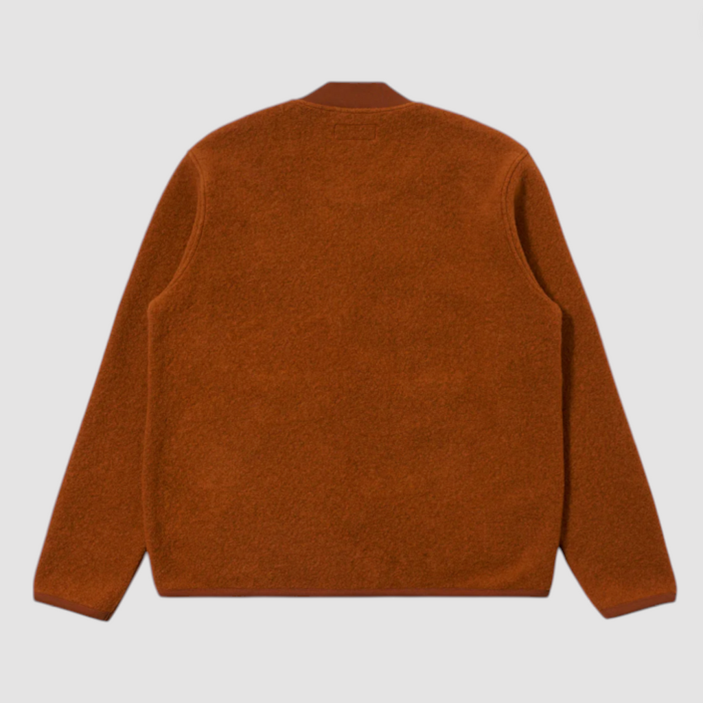 Orange zip up jacket on a light gray background.