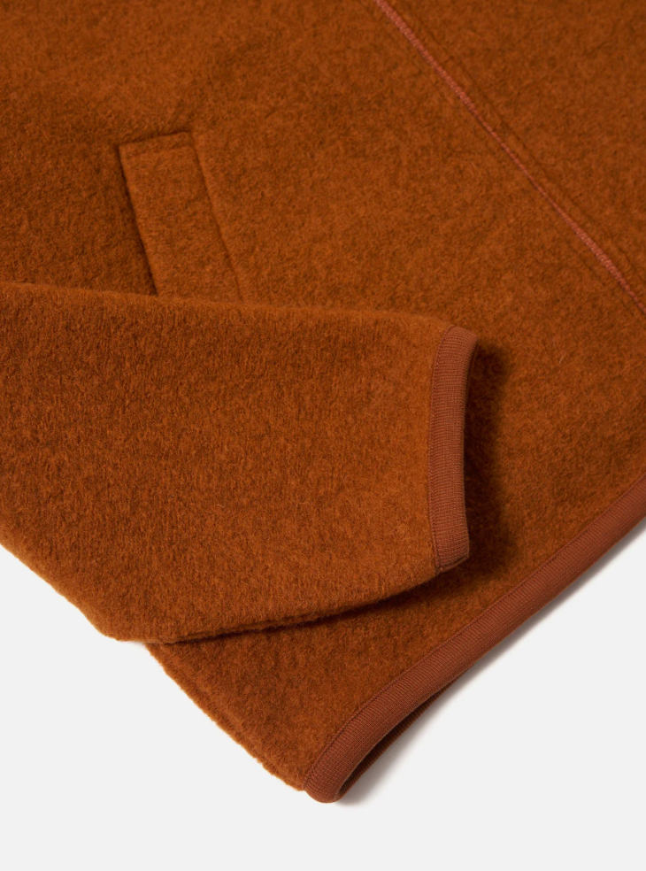 Orange fabric with a textured pattern on a white background.
