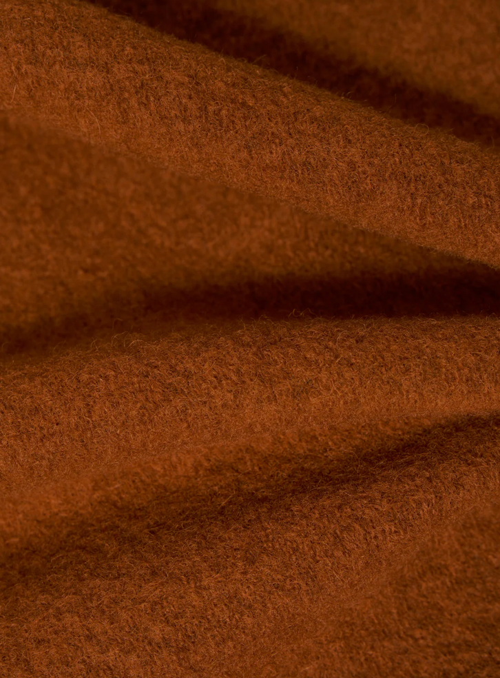 Close-up of orange fleece fabric texture.