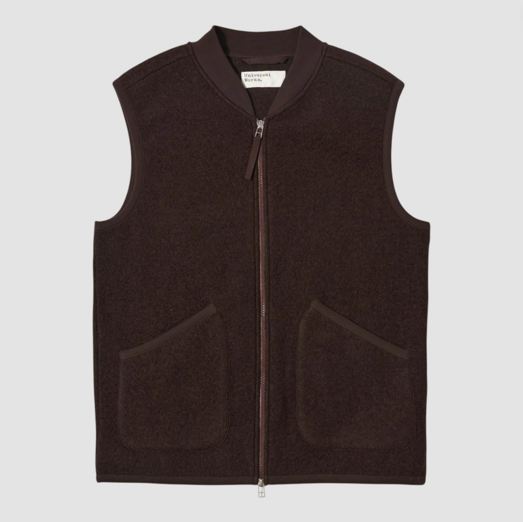 Brown vest with a zipper on a light gray background.