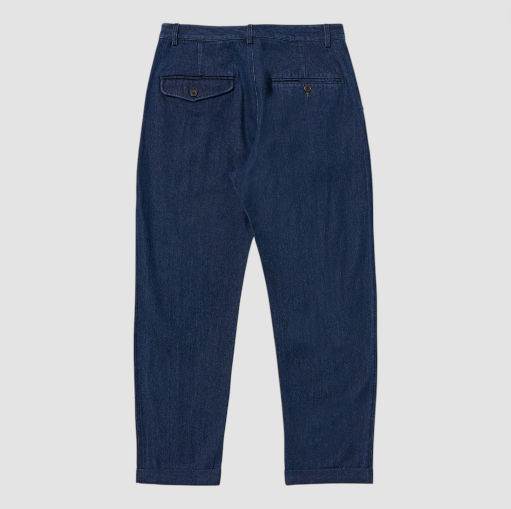 Pair of blue denim pants on a light gray background.
