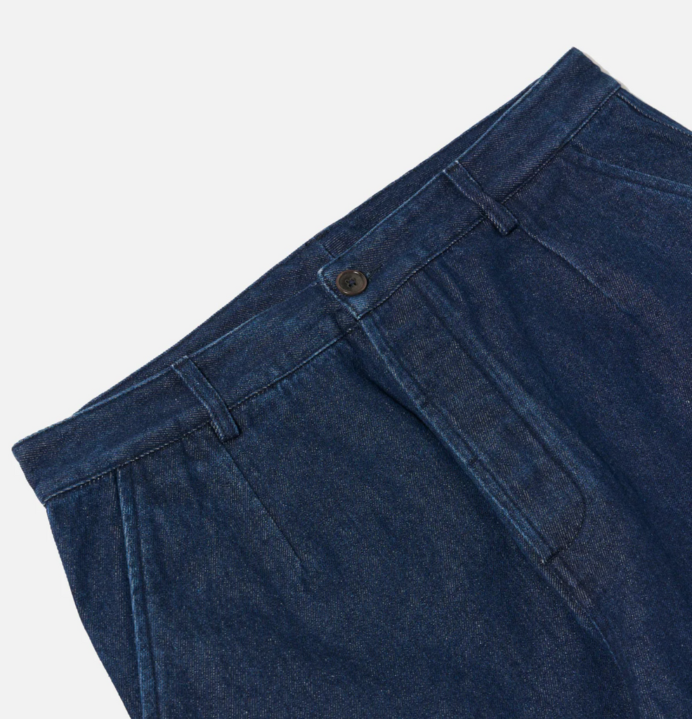 Blue denim pants on a light gray background.