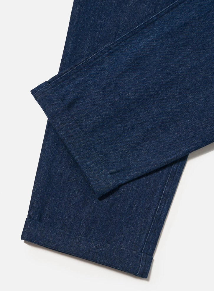Folded blue denim fabric on a light gray background.