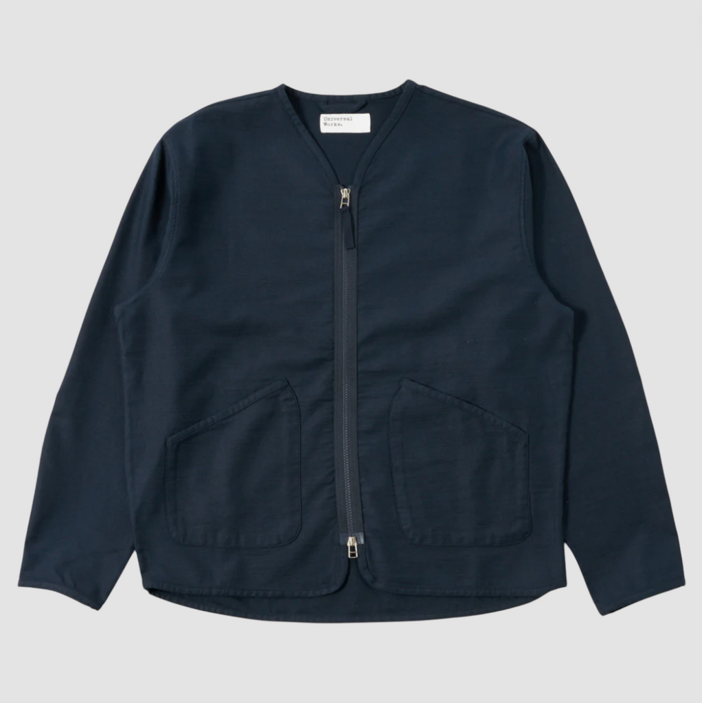 Navy slub sateen jacket with a loose fit, two-way zip, chest and lower patch pockets, and cotton binding trim.