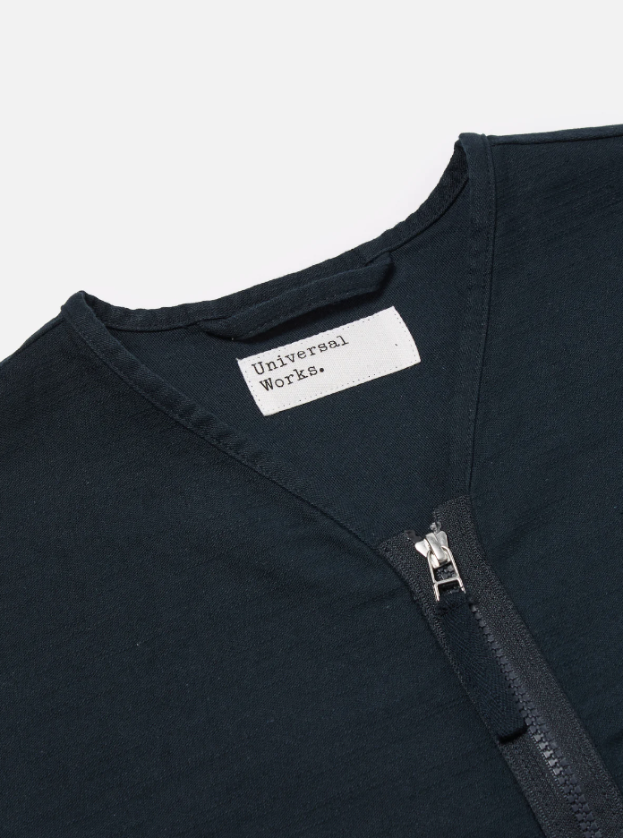 Navy slub sateen jacket with a loose fit, two-way zip, chest and lower patch pockets, and cotton binding trim.