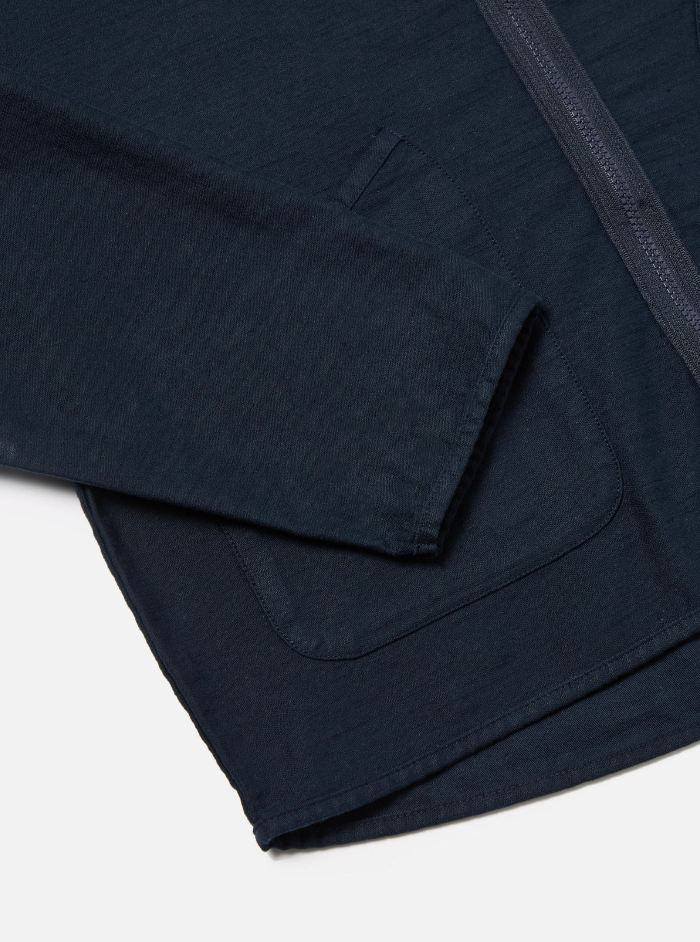 Navy slub sateen jacket with a loose fit, two-way zip, chest and lower patch pockets, and cotton binding trim.